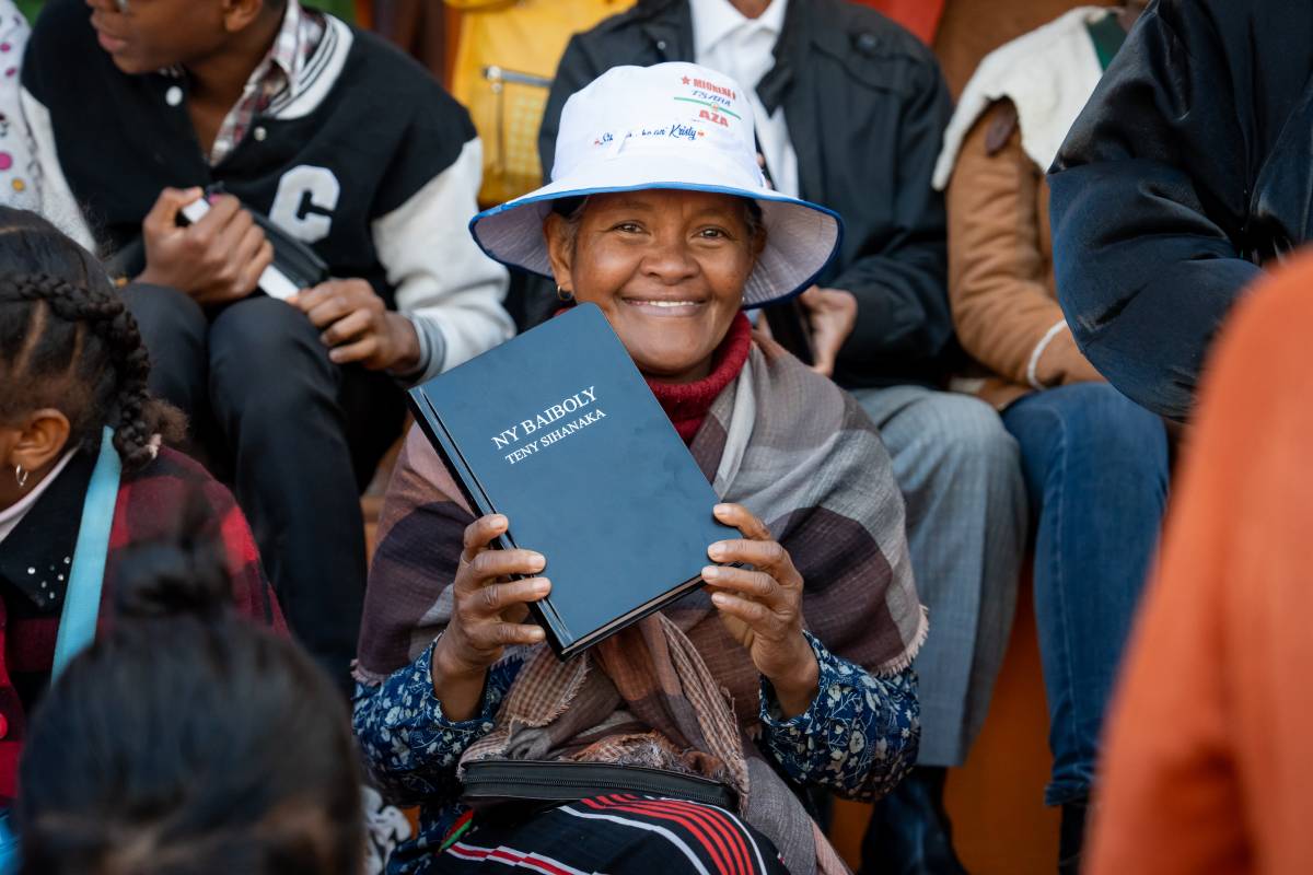 Woman from a Madagascar Scripture Celebration holding up her Bible.